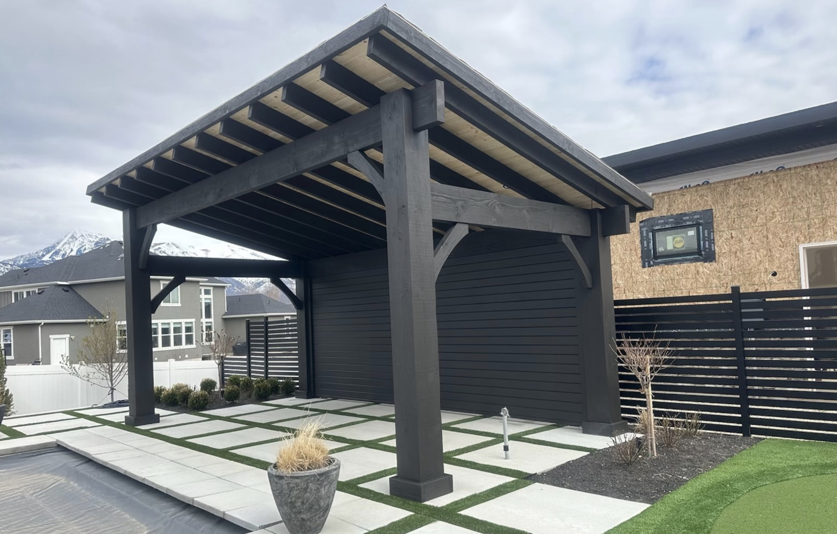 Modern Solid Wood Pergola Design Outdoor solid wood pergola with black beams and open roof design, built beside a backyard patio and garden space