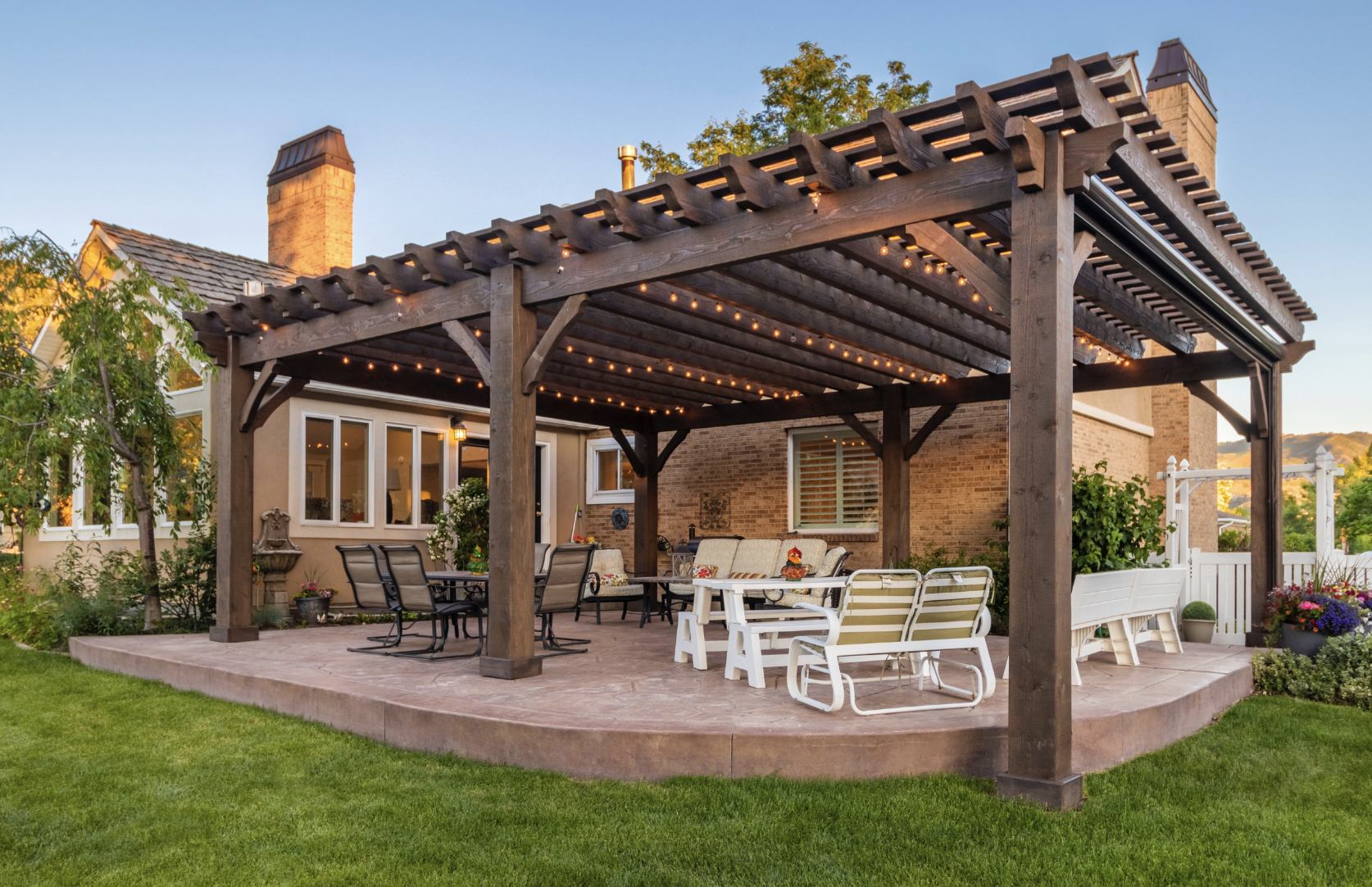 Backyard Pergola Outdoor Living Space Large timber pergola with string lights and patio seating, highlighting outdoor living benefits in the pergola vs trellis comparison