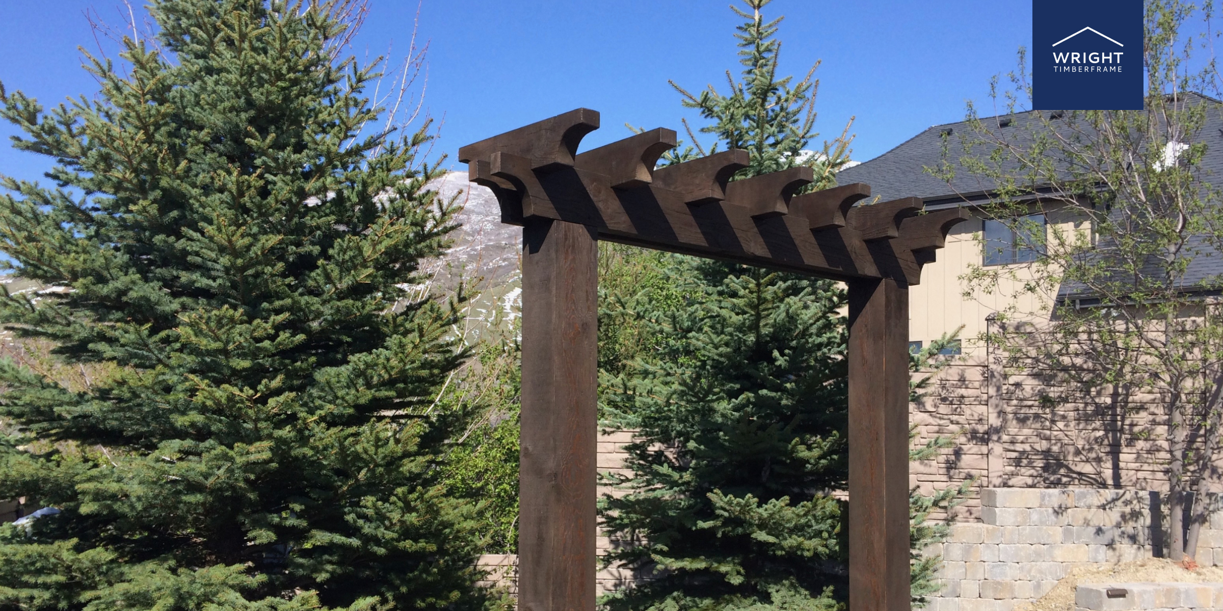 Custom Wood Trellis in Natural Timber Finish Outdoor custom wood trellis with dark timber beams beside evergreens, showing joinery details and crafted design