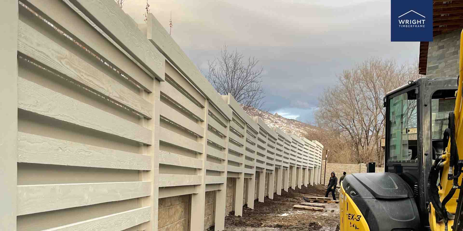 Large custom timber trellis wall under construction in Utah, built by expert timber frame professionals for privacy and style