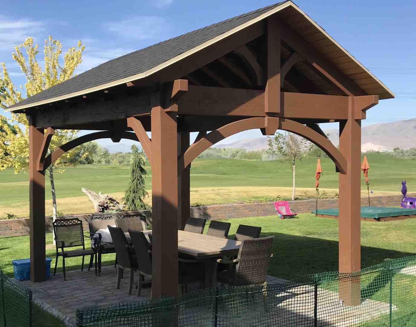 family dining under a spacious timber pergola - Pergola builders Utah