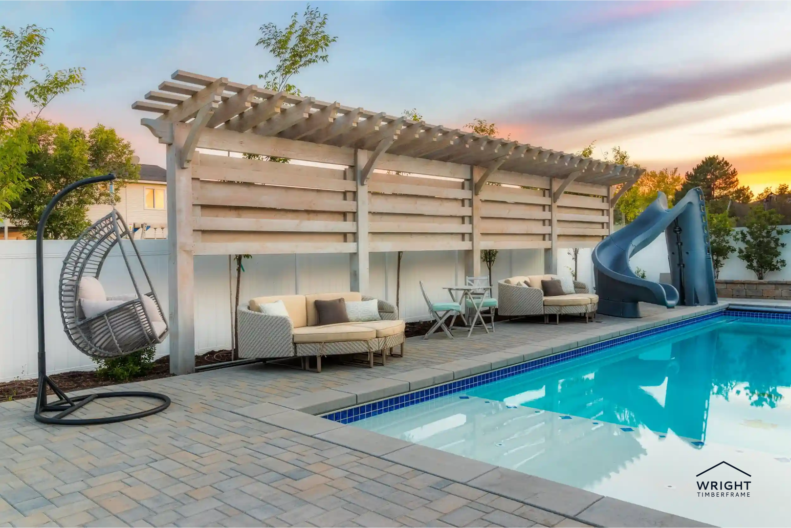 Poolside pergola with lounge seating and privacy panels, highlighting modern outdoor living additions for relaxing backyard spaces.