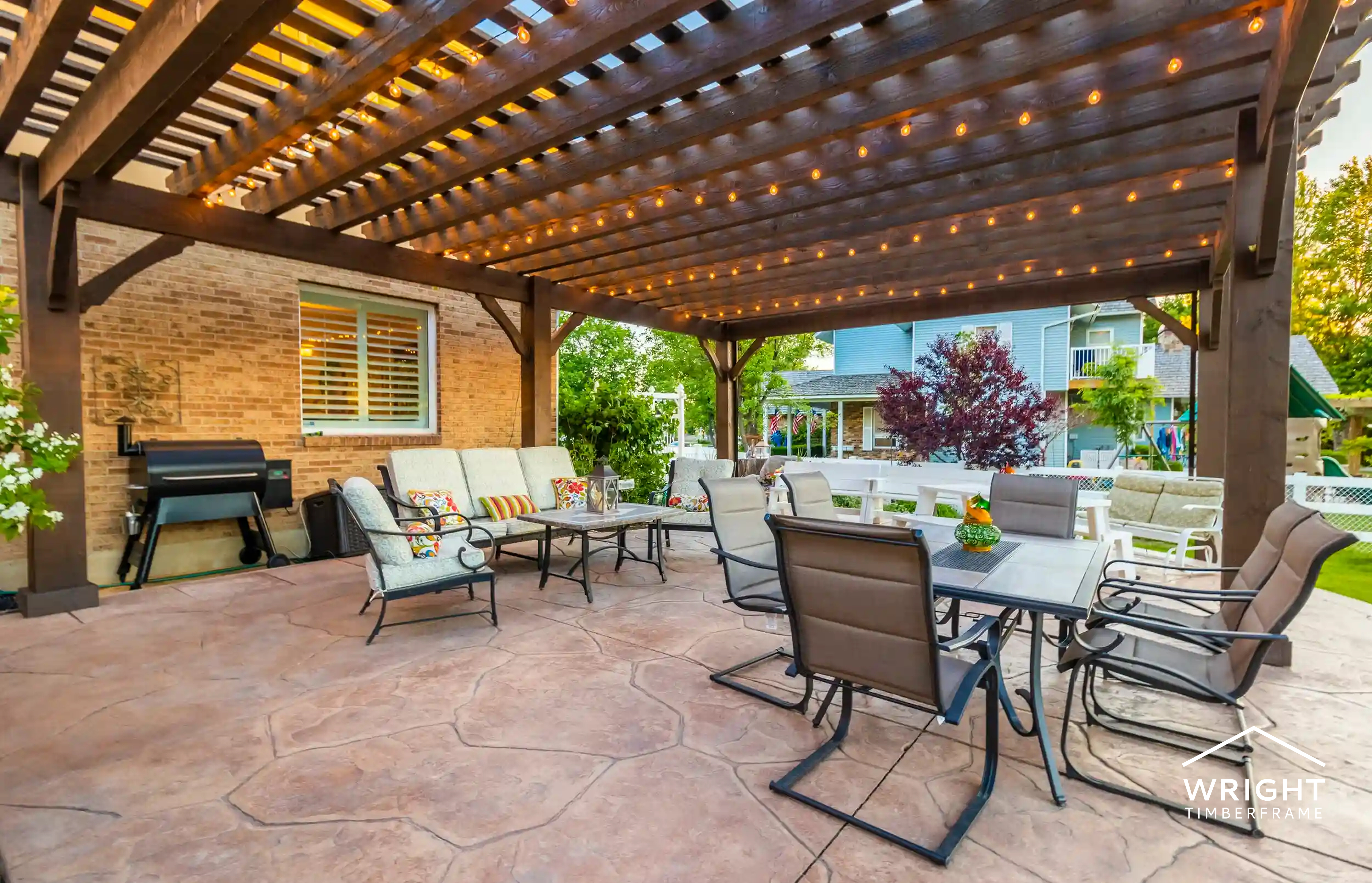 Spacious backyard pergola with string lights, dining area, and seating, highlighting the best time to buy a pergola.