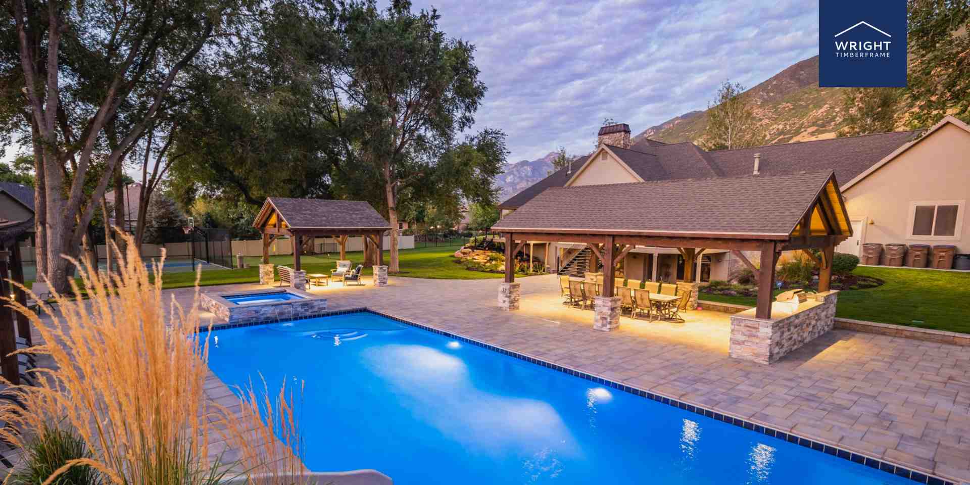 Custom Backyard Timber Frame Pavilion by the Pool Custom backyard timber frame pavilion beside a swimming pool, showcasing exposed beams, stone columns, and outdoor living design.