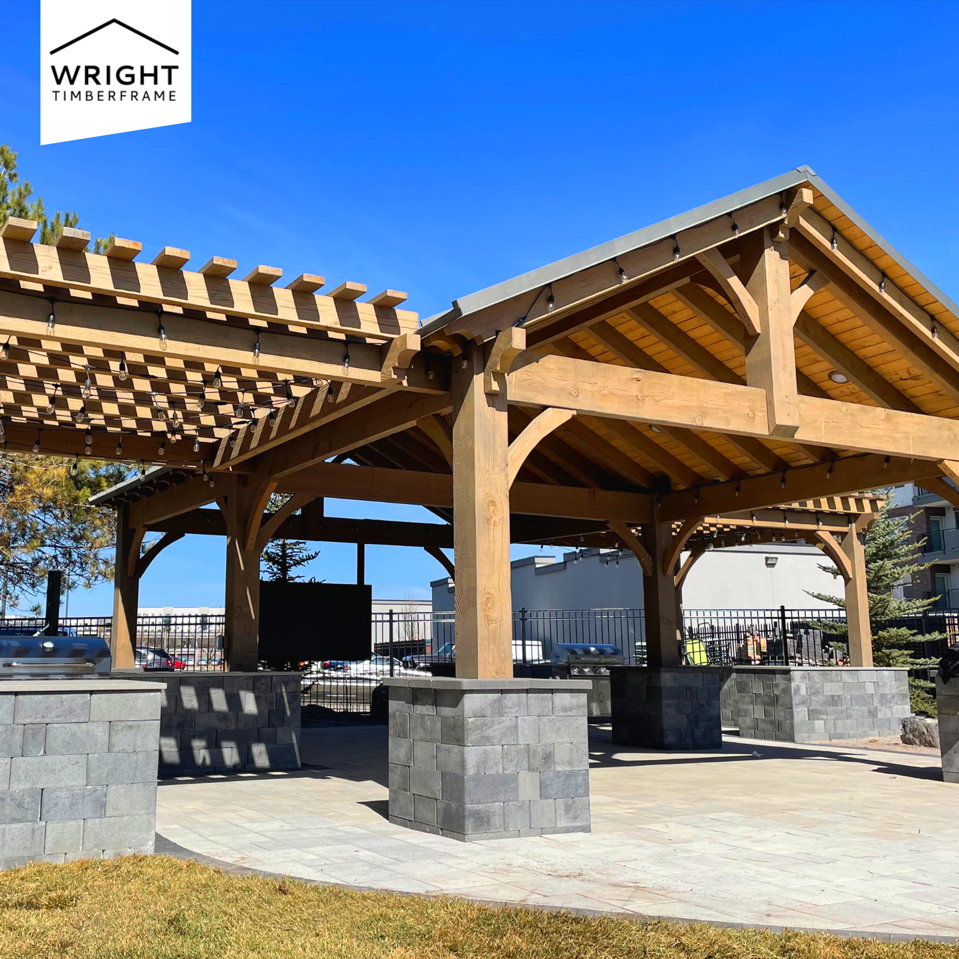 Timber frame pavilion with open-air seating and pergola extension, showcasing ideas for How to Heat a Pavilion year-round.