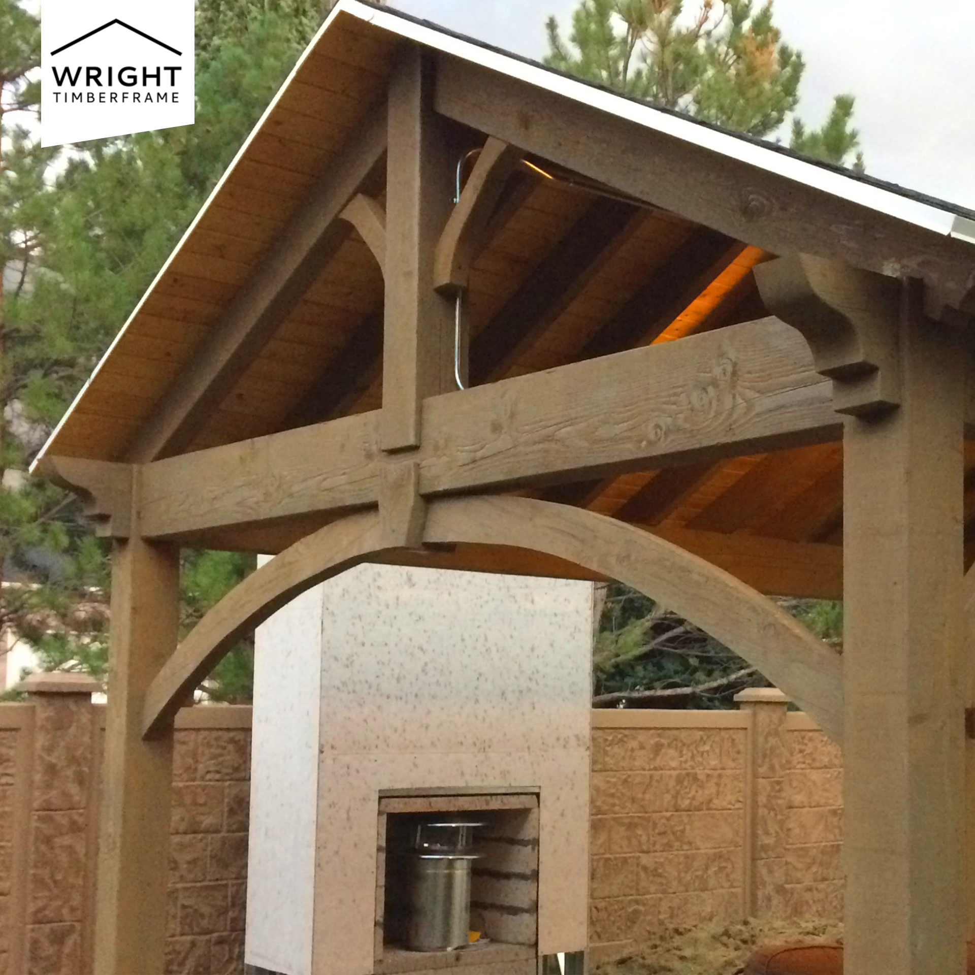 How to Heat a Pavilion with a timber frame structure featuring a built-in fireplace for year-round outdoor comfort and warmth.