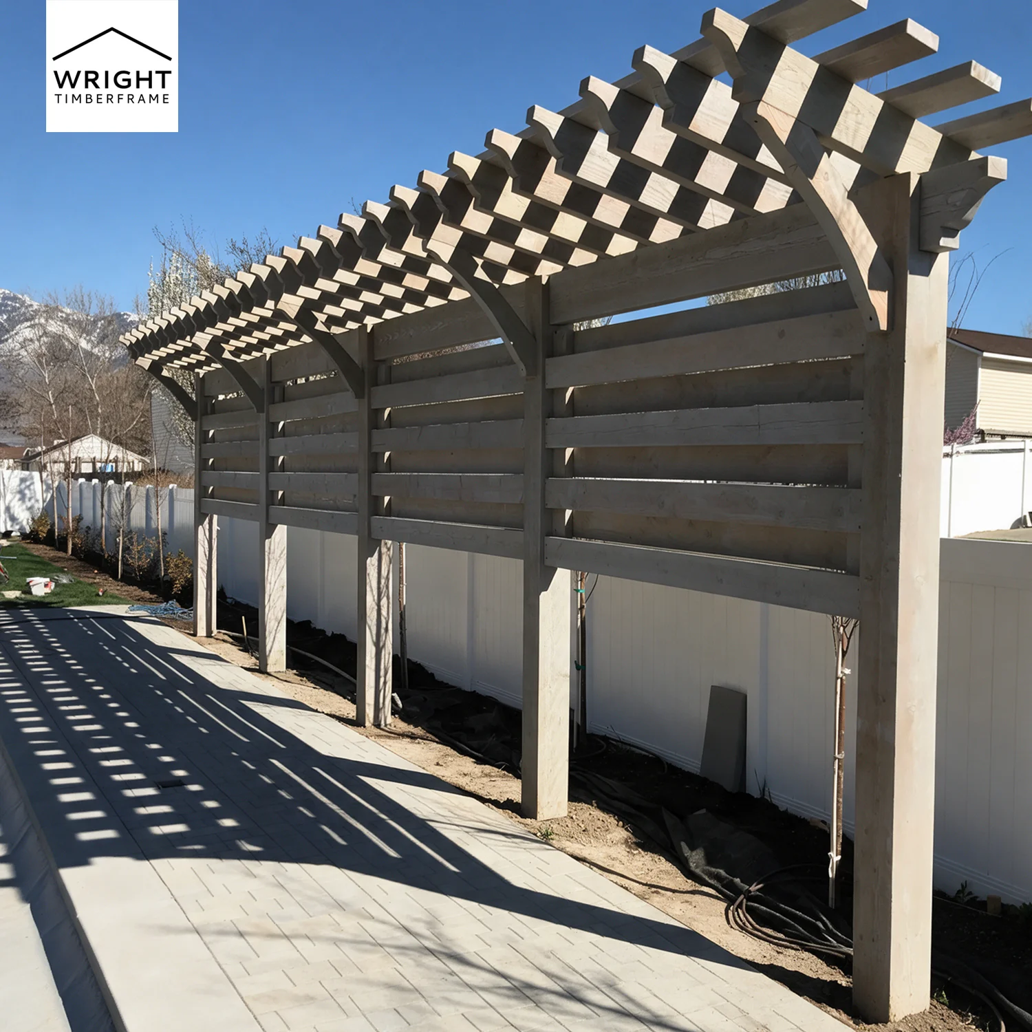 Light grey wooden shade structure showing lattice roofing elements when choosing a pergola vs pavilion vs trellis kit.